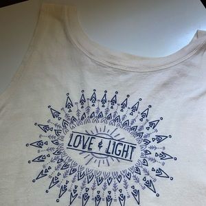 Cream “love & light” tank; worn once; open back; bought from a boutique
